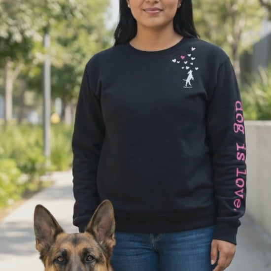 woman wearing black crewneck fleece standing next to dog