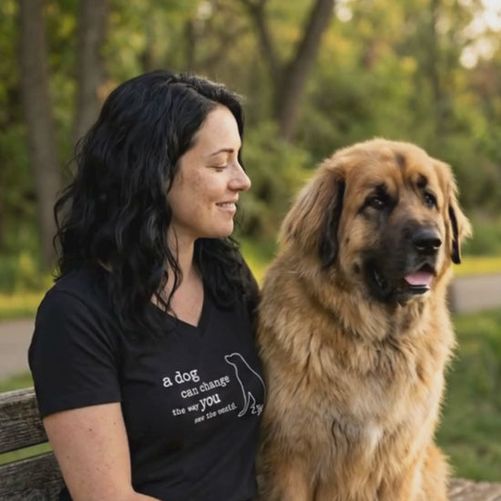 woman sitting in a park with her dog