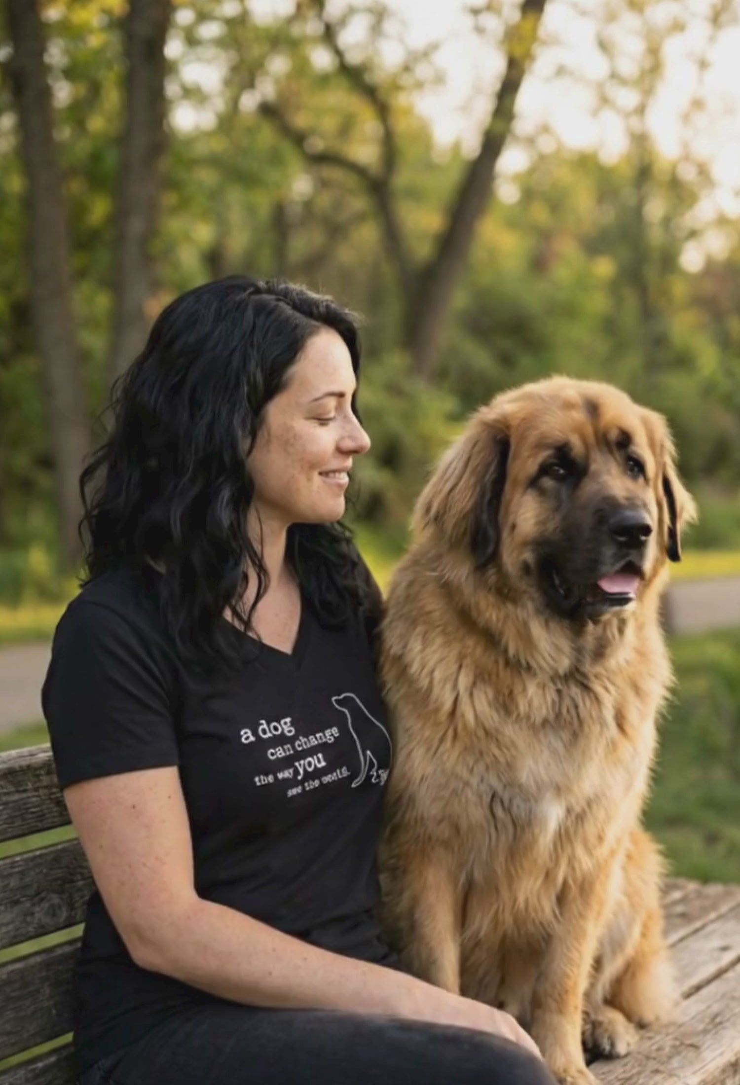 woman sitting in a park with her dog